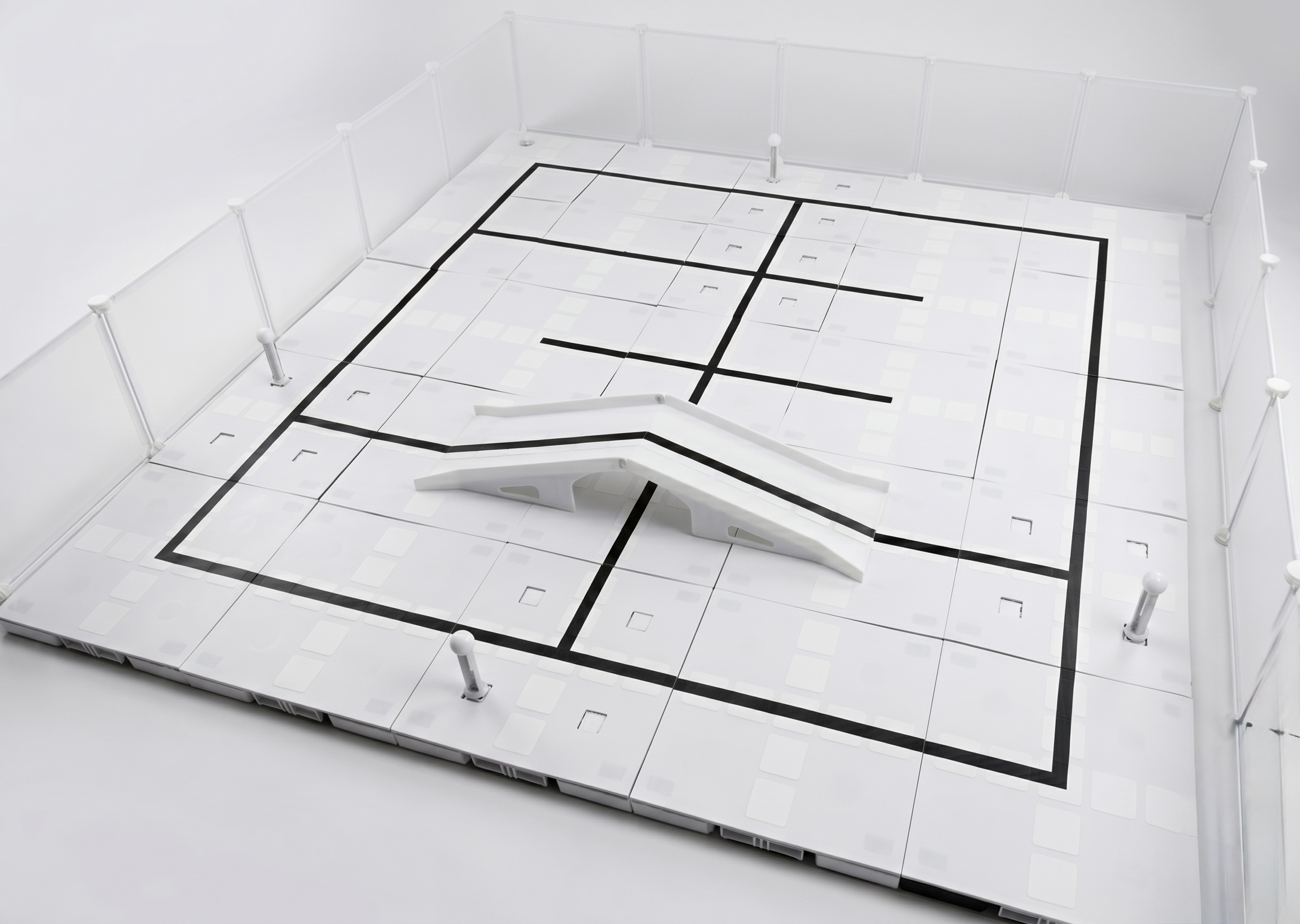 Interactive playfield with smart tiles and sensory objects.